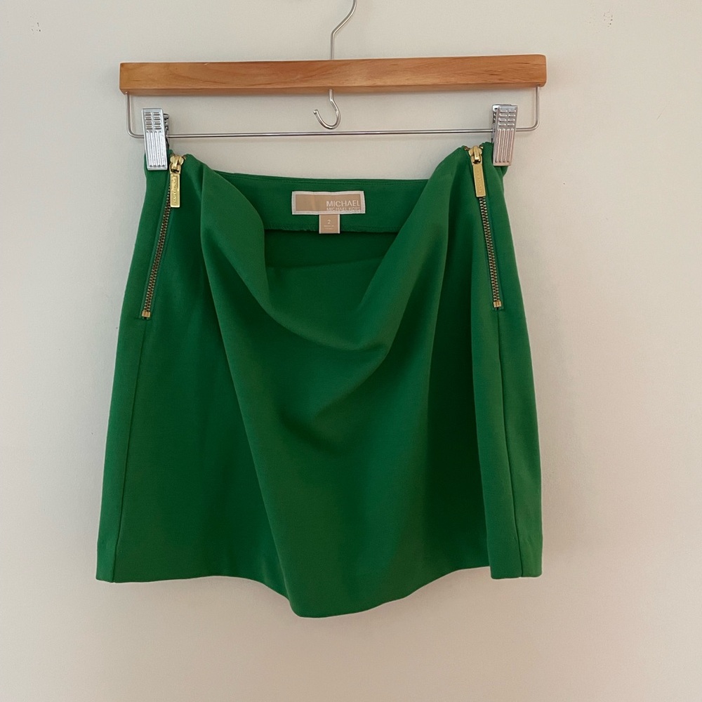 Michael Kors green mini skirt. Size 2. Gold zippers down each side.